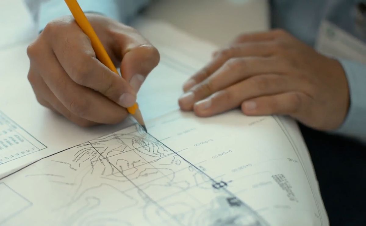 Engineer marking up a site plan by hand